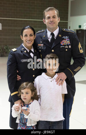 2nd Lt. Marisa Lindsay poses with her husband, Master Sgt. Michael Lindsay, Special Forces Advisor with the 1-196th Infantry Regiment, son Liam, 10, and daughter Esmarin, 4, after a commissioning ceremony at the National Guard armory on Joint Base Elmendorf-Richardson, Alaska, May 21, 2017. Lindsay earned the distinction of Honor Graduate and was recognized with the High Physical Fitness Award from the Officer Candidate School at the Alabama Military Academy.    (U.S. Army National Guard photo by Spc. Michael Risinger) Stock Photo