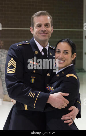 2nd Lt. Marisa Lindsay poses with her husband, Master Sgt. Michael Lindsay, Special Forces Advisor with the 1-196th Infantry Regiment, after a commissioning ceremony at the National Guard armory on Joint Base Elmendorf-Richardson, Alaska, May 21, 2017. Lindsay earned the distinction of Honor Graduate and was recognized with the High Physical Fitness Award from the Officer Candidate School at the Alabama Military Academy.    (U.S. Army National Guard photo by Spc. Michael Risinger) Stock Photo