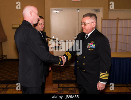 170522-N-OK605-018 MISAWA, Japan (May 22, 2017) Capt. Matt Welsh, U.S. Naval Computer and Telecommunications Station Far East (NCTSFE) Commanding Officer, shakes hands with Chief Warrant Officer 3 William Behr during NCTSFE Misawa Deatchment's change of command. Chief Warrant Officer 3 William Behr relinquished command to Chief Warrant Officer 2 Ronnie Stowers. (U.S. Navy Photo by Mass Communication Specialist 2nd Class Samuel Weldin/Released) Stock Photo