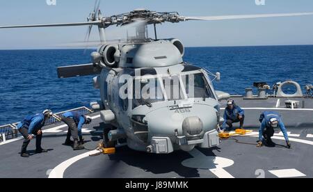 170523-N-FQ994-257 MEDITERRANEAN SEA (May 23, 2017) Sailors chock and chain an MH-60R Sea Hawk helicopter, assigned to Helicopter Maritime Strike Squadron (HSM) 46, Det. 1, during flight quarters aboard the Arleigh Burke-class guided-missile destroyer USS Ross (DDG 71) May 23, 2017. Ross, forward-deployed to Rota, Spain, is conducting naval operations in the U.S. 6th Fleet area of operations in support of U.S. national security interests in Europe and Africa. (U.S. Navy photo by Mass Communication Specialist 3rd Class Robert S. Price/Released) Stock Photo