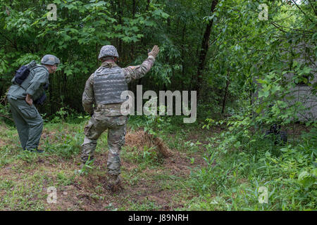 Soldiers of the 753rd Explosive Ordnance Disposal (EOD) of Kingwood, W.Va., and members of the West Virginia State Police Bomb Squad participated in a Raven's Challenge that took place at Camp Dawson, Kingwood, from May 21-26, 2017. Raven's Challenge is an annual, interagency, counter IED exercise that incorporates scenarios focused on interoperability capabilities between public safety bomb squads and military EOD units in operational domestic type IED environments. The exercise also provided international participation. (U.S. Army photo by Sgt. Penni Harris) Stock Photo