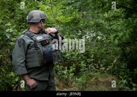 Soldiers of the 753rd Explosive Ordnance Disposal (EOD) of Kingwood, W.Va., and members of the West Virginia State Police Bomb Squad participated in a Raven's Challenge that took place at Camp Dawson, Kingwood, from May 21-26, 2017. Raven's Challenge is an annual, interagency, counter IED exercise that incorporates scenarios focused on interoperability capabilities between public safety bomb squads and military EOD units in operational domestic type IED environments. The exercise also provided international participation. (U.S. Army photo by Sgt. Penni Harris) Stock Photo