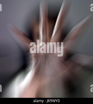 A girl trying to stop the camera to shot by getting her hand against it . Stock Photo