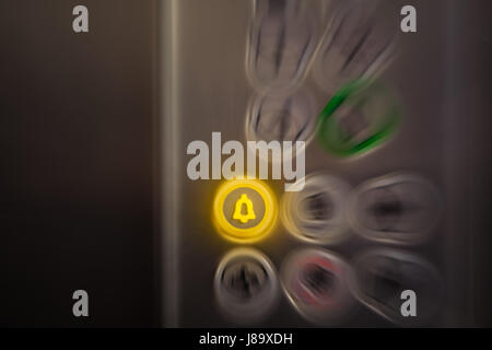 Close up of elevator alarm and panic button on control panel. Button is switched on. Emergency and call for help concepts. Stock Photo