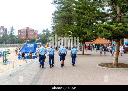 Sydney New south wales police officers team of four 4 on patrol at Manly Beach,Sydney,Australia