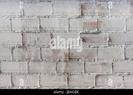 Detail of a brick wall painted in white Stock Photo