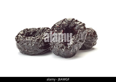 Three dried plums on white Stock Photo