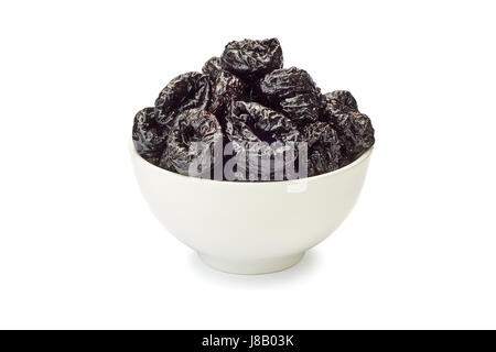 Bowl of dried plums on white Stock Photo