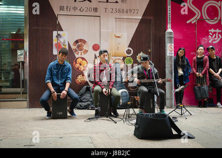 Street performers at night in Hong Kong's busy Mong Kok Disrict Stock Photo