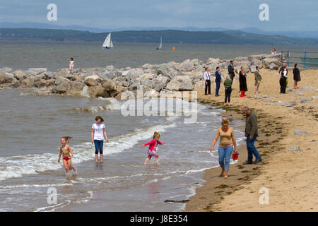 May beach scene in Morecambe, Lancashire, UK.  UK Weather. 28th May, 2017.  Sun breaks through on Morecambe Bay with the Lake District hills in the background.  After overnight rain, the warm temperatures are set to return to the seaside resort. Stock Photo