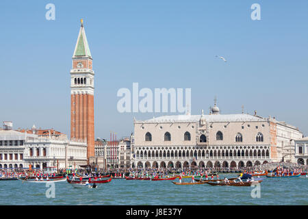 Venice, Veneto, Italy. 28th May, 2017. Participants in the Fete de la Sensa Venice, Veneto Italy with rowing teams in their boats in front of the Doges Palace and Campanile accompanying the Serrenisimo historial boat carrying the dignatories to Lido for the blessing of the gold ring which is then tossed into the lagoon marrying Venice to the sea. Stock Photo