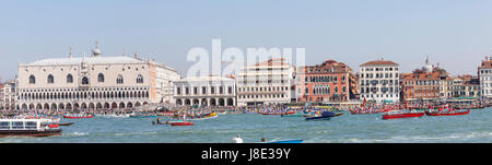 Venice, Veneto, Italy. 28th May, 2017. Panorama view of St Marks Basin with the cortege of rowers in the boats accompanying the Serenissama ceremonial boat with the dignatories to Lido for the blessing of the gold ring which is then tossed into the lagoon marrying Venice to the sea. Stock Photo