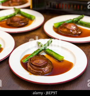 Cantonese cuisine whole abalone with asparagus Stock Photo