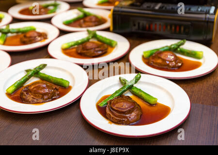 Cantonese cuisine whole abalone with asparagus Stock Photo