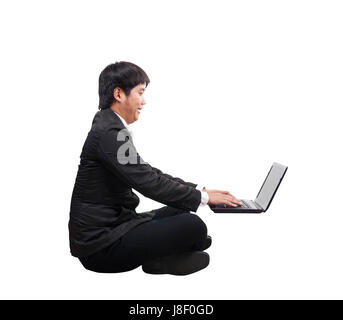 young business man working on computer laptop with happy and funny face isolated white background Stock Photo