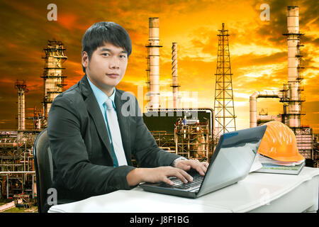 portrait young engineering man sittin and working on laptop computer ...