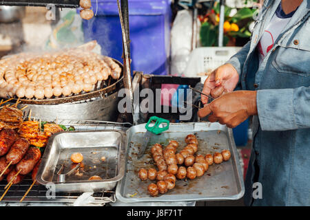 CHIANG MAI, THAILAND - AUGUST 21: Thai woman cooks meatballs at the Sunday Market (Walking Street) on August 21, 2016 in Chiang Mai, Thailand. Stock Photo