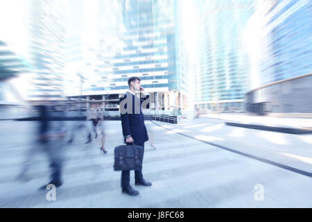 Handsome businessman talking on the cellphone outside office building Stock Photo
