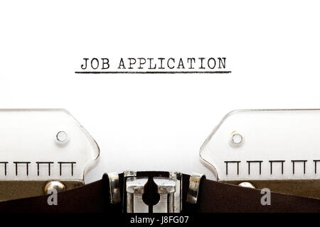 Headline Job Application typed on old typewriter. Stock Photo