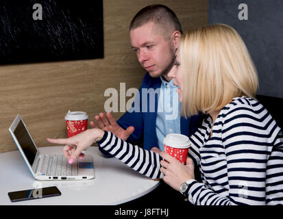 young people discuss the idea over coffee Stock Photo