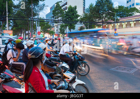Ho Chi Minh City, Vietnam - November 19, 2015: Motorbike drivers are waiting for the green signal at the crossroad on November 19, 2015 in Ho Chi Minh Stock Photo