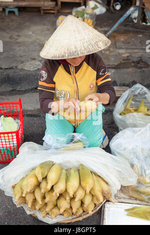 Nha Trang, Vietnam - December 02, 2015: Vietnamese woman is selling corn at the street market, Nha Trang, Vietnam on December 02, 2015. Stock Photo