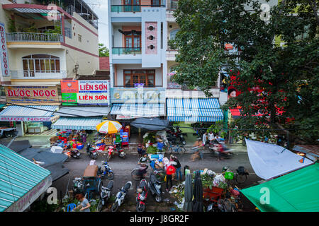 Nha Trang, Vietnam - January 09, 2016: Crowd of people selling goods and making purchases at the night street market. Stock Photo