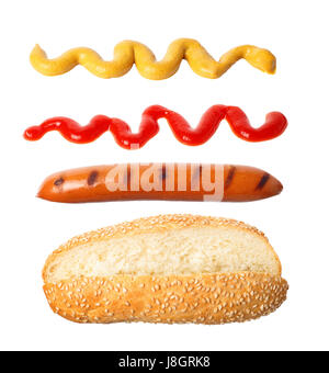 hot-dog with falling ingredients - grilled sausage, sauce ketchup and mustard isolated on white background.  Hot dog ingredients in the air. Fly food Stock Photo