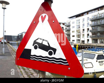 A caution sign to warn cars not to drive into the water. Stock Photo