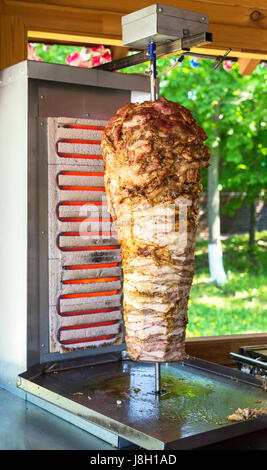 Traditional fast food Turkish doner kebab meat on a rotary grill Stock Photo