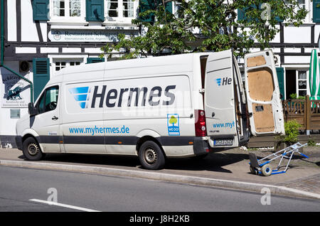 Hermes delivery van in front of a half-timber house. Hermes is Germany’s largest post-independent provider of deliveries to private customers. Stock Photo