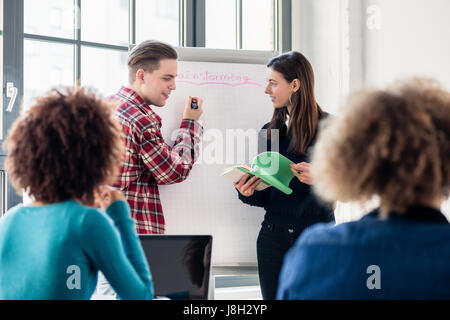Students sharing ideas and opinions while brainstorming during a Stock Photo