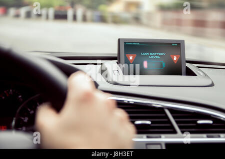 Low battery warning in the electric car. Stock Photo