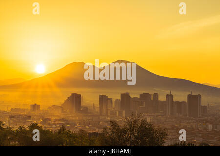 The Sun is rising over the Mount Vesuvius in Naples, Italy Stock Photo