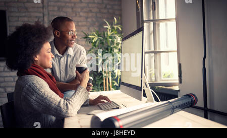 Young employees in architect office working on computer Stock Photo