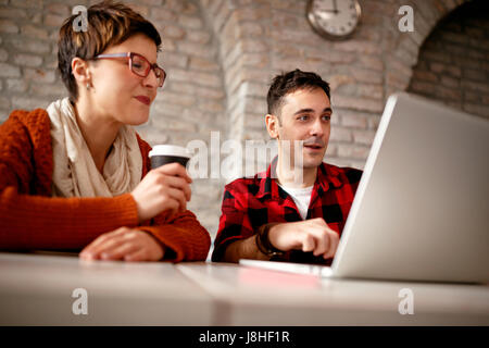young architect couple working late at computer in office Stock Photo