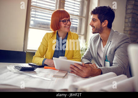 Working on design- architect enjoying working on project together Stock Photo