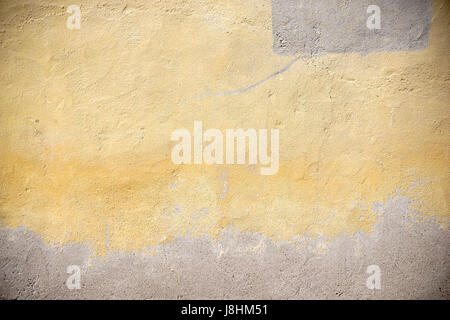 The closeup of a faded facade and peeling plaster. Stock Photo
