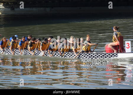 KAOHSIUNG, TAIWAN -- MAY 21, 2017: A team of foreign students trains on the Love River in preparation for the upcoming Dragon Boat Festival. Stock Photo