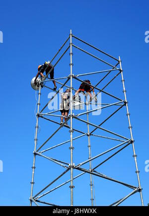 KAOHSIUNG, TAIWAN -- MAY 21, 2017: Workers set up powerful lights on scaffolds in preparation for the upcoming Dragon Boat Festival. Stock Photo