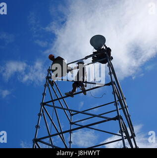 KAOHSIUNG, TAIWAN -- MAY 21, 2017: Workers set up powerful lights on scaffolds in preparation for the upcoming Dragon Boat Festival. Stock Photo