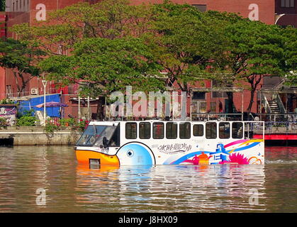 KAOHSIUNG, TAIWAN - MAY 21, 2017: An amphibious tourist bus transports visitors on the Love River in Kaohsiung City. Stock Photo