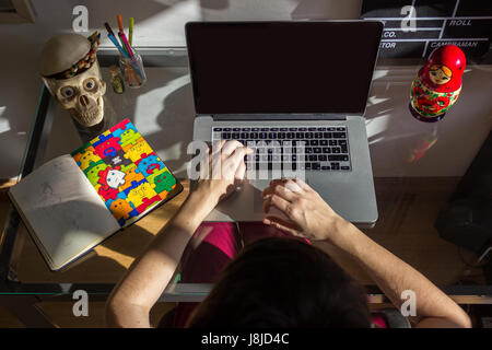 Brazil, Rio de Janeiro - May 27, 2016: Young creative working on computer Stock Photo