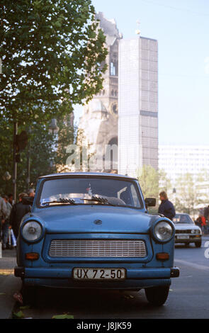 An East German Trabant, a small car with a two-cylinder engine, is parked on the Ku'damm in West Berlin.  East Germans are visiting the West following demolition of sections of the Berlin Wall. Stock Photo