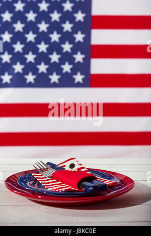Beautiful blue red and white table setting in front of american flag Stock Photo
