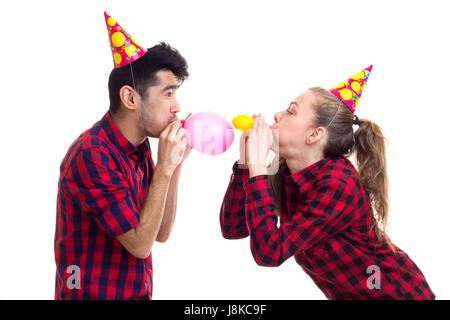Young couple blowing balloons Stock Photo