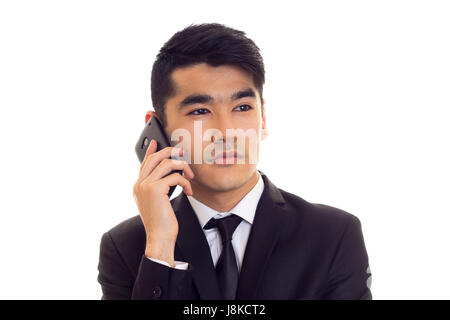 Young man in suit talking on the phone Stock Photo