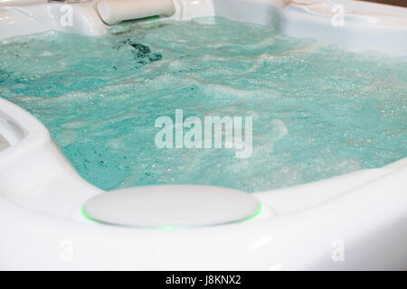 Modern bubbling jacuzzi in a spa or in a luxury hotel, apartment. Stock Photo