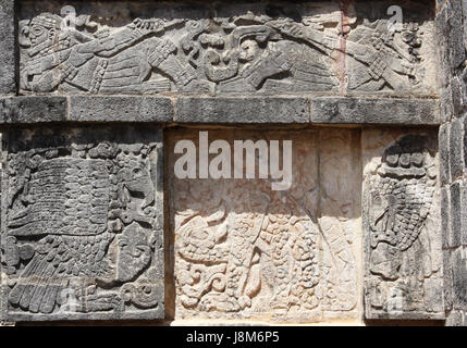 Bas-relief carving of a jaguar, eagle and lying mayan warriors, pre-Columbian Maya civilization, Chichen Itza, Yucatan, Mexico. UNESCO world heritage  Stock Photo