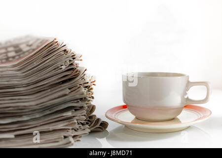 Newspapers and Coffee on the white table . Stock Photo